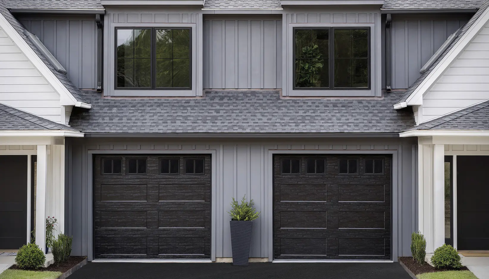 Bridgeport™ Steel garage door with extended recessed panels and REC12 windows in black