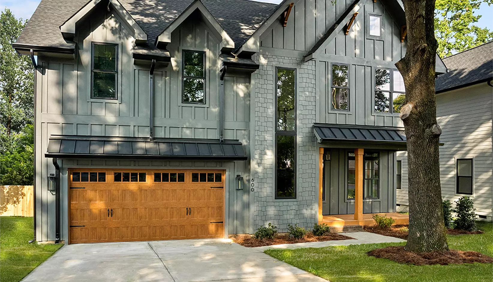 Bridgeport Steel garage door with narrow recessed panels and REC14 windows in Ultra-Grain Oak Medium finish