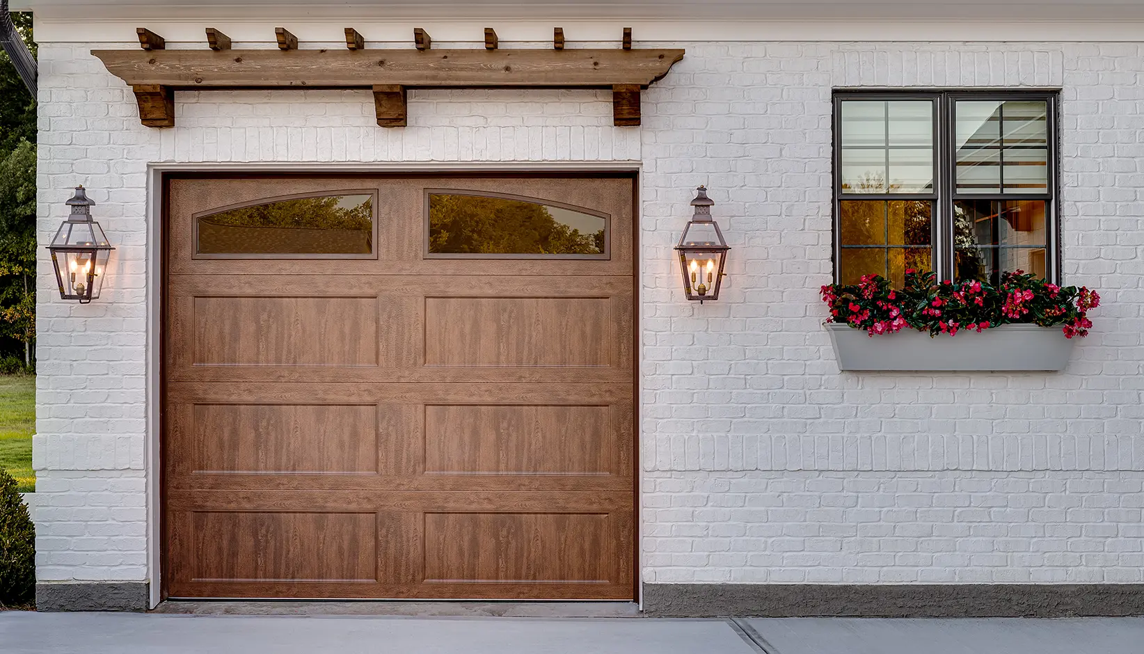 Bridgeport™ Steel garage door with extended recessed panels and ARCH1 Plain windows in Ultra-Grain® Dark finish