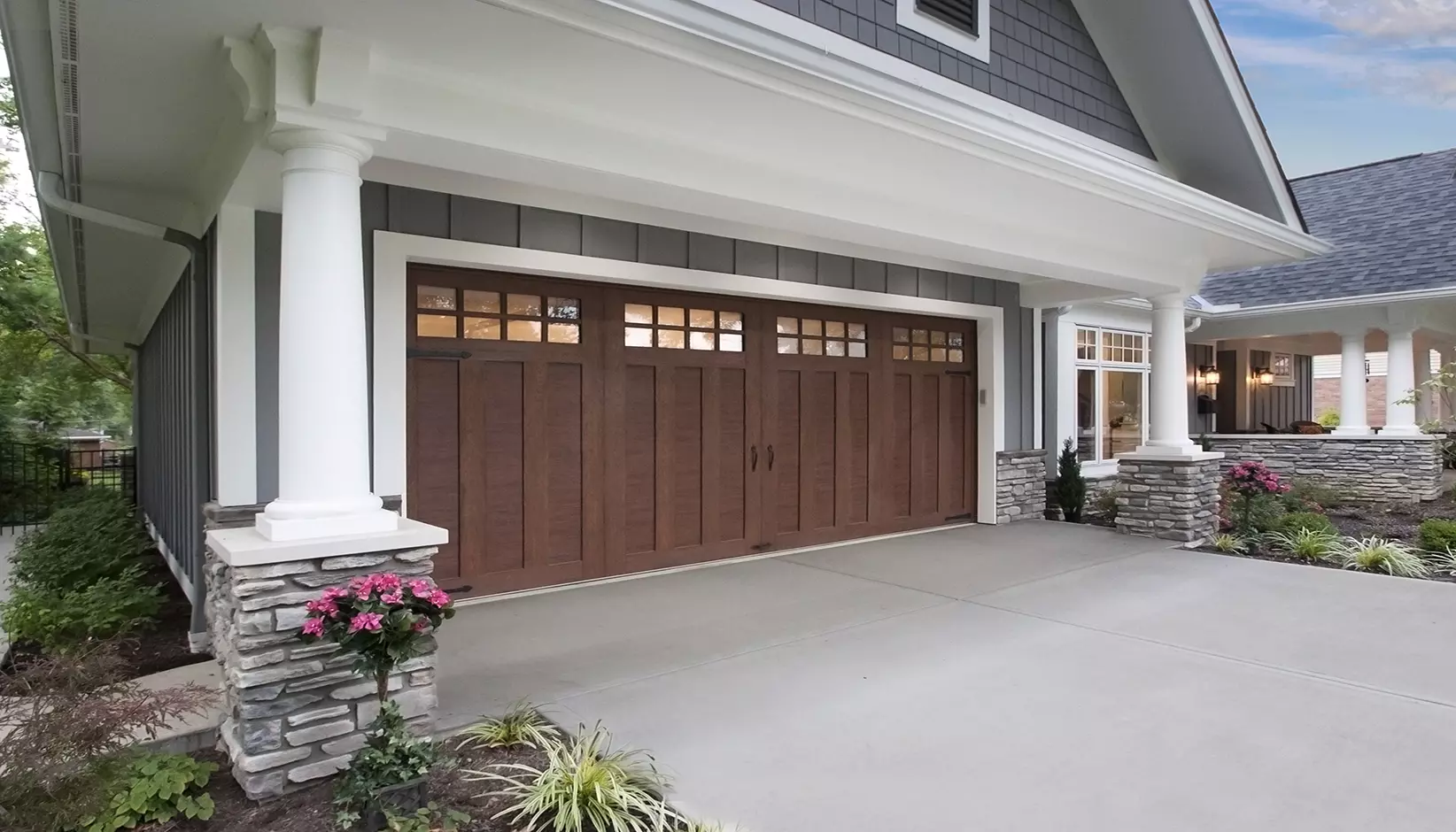 Canyon Ridge 4-Layer garage door in Design 13 with SQ24 windows in Ultra-Grain® Cypress Walnut Finish