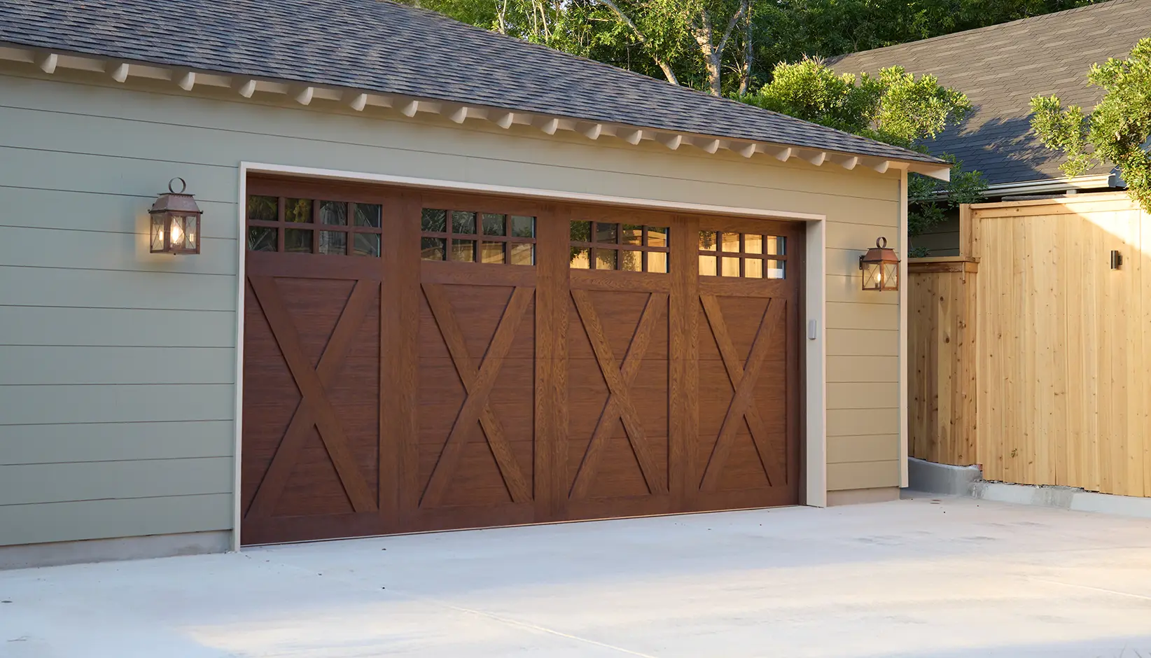 Canyon Ridge 4-Layer garage door in Design 21 with SQ24 windows in Ultra-Grain® Cypress Walnut Finish