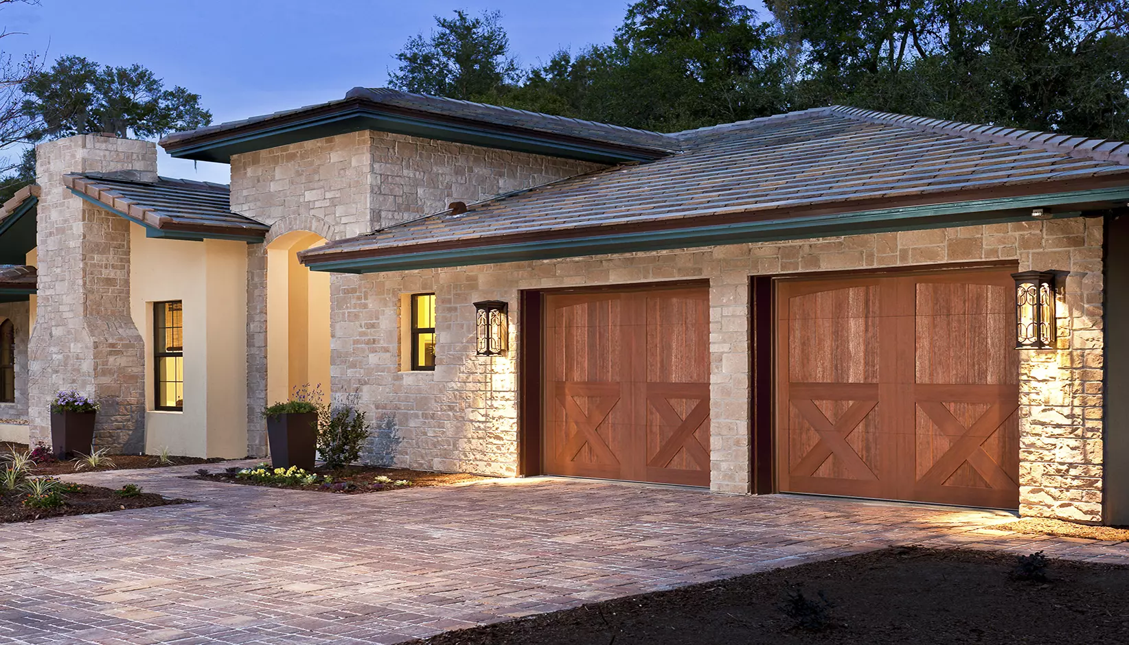 Canyon Ridge 5-Layer garage in door in Design 38 with ARCH1 solid top section in Medium finish