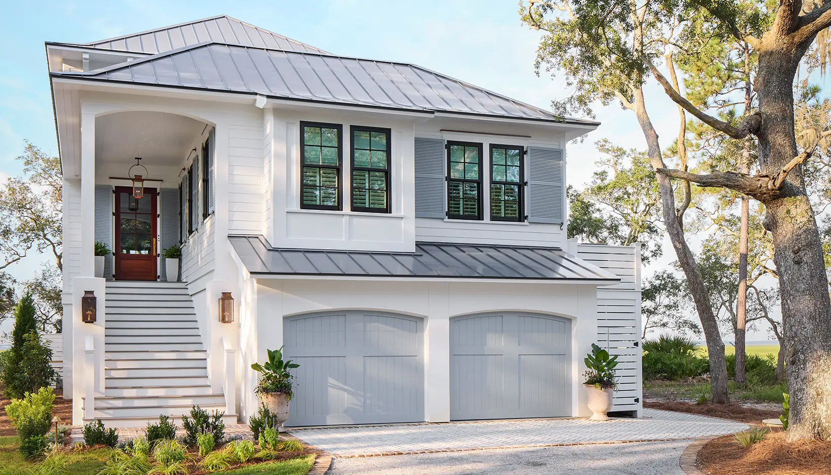 Canyon Ridge 5-Layer garage door in Design 36 with ARCH1 top Sherwin Williams Uncertain Gray