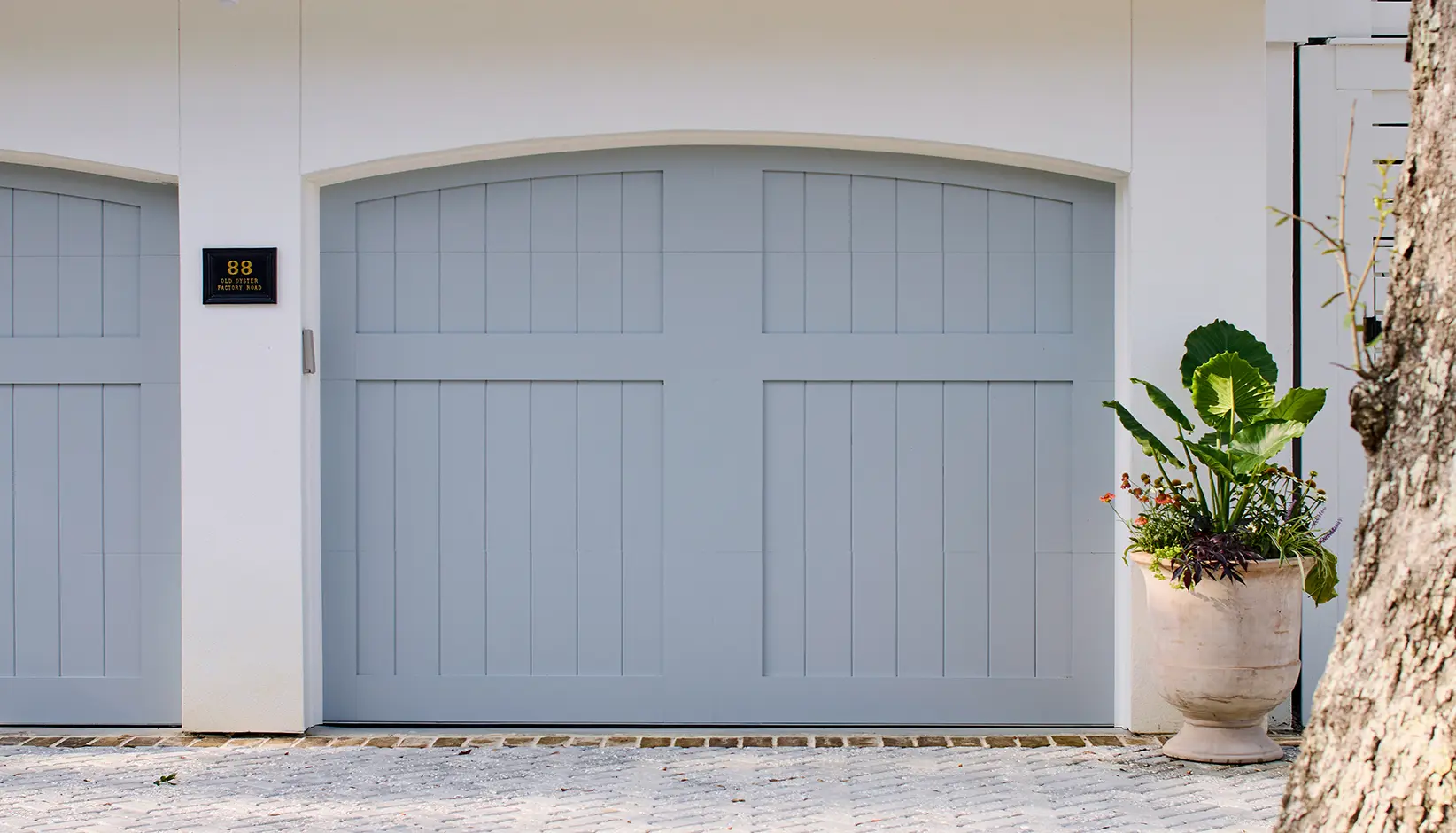 Canyon Ridge 5-Layer garage door in Design 36 with ARCH1 top Sherwin Williams Uncertain Gray