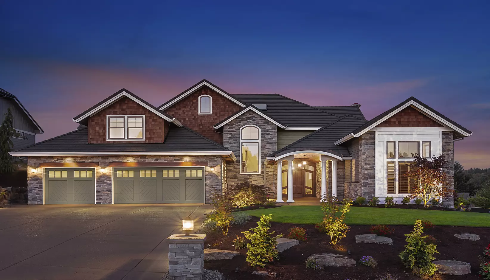 Canyon Ridge® Chevron garage door in Design 11, Option V with REC13 windows in Bronze