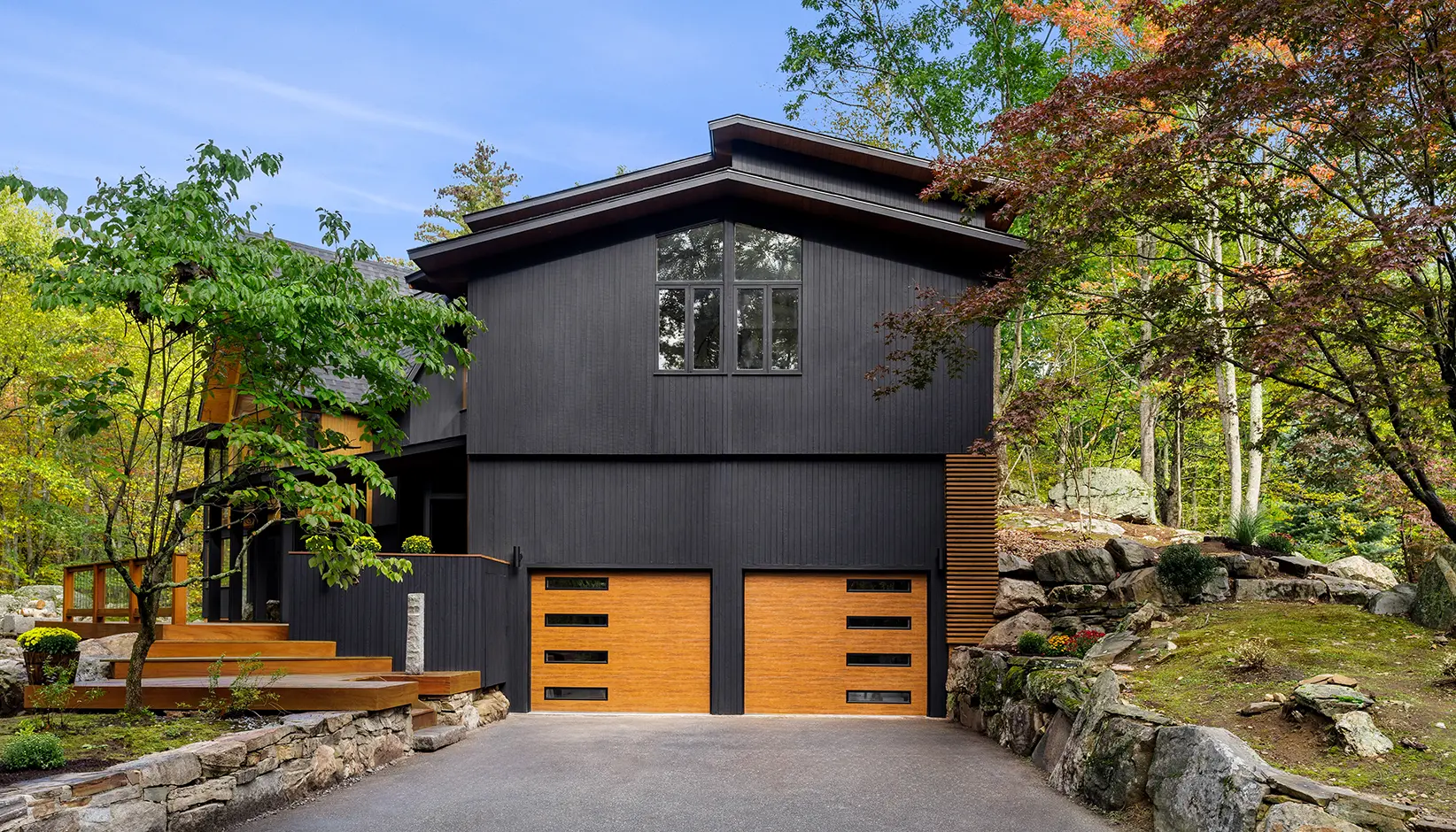 Modern Steel garage door in Ultra-Grain Medium Finish with contemporary slim windows in black