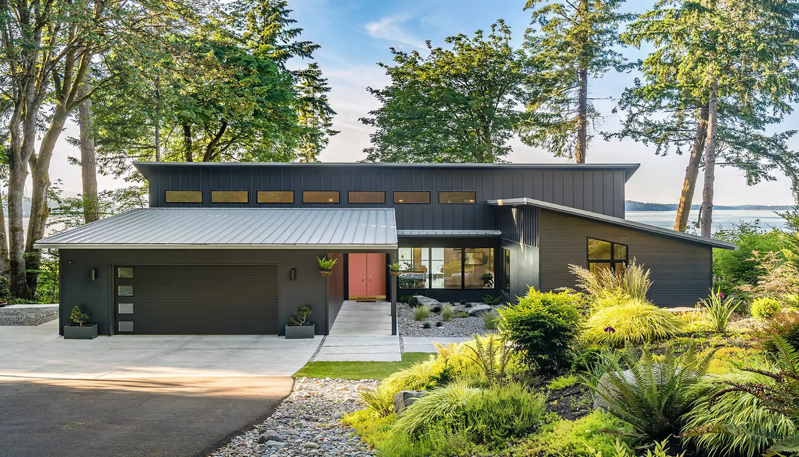 Modern Steel garage door with grooved panels and short plain windows in black